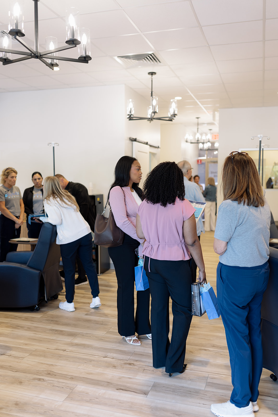 The IV lounge at Hydralive Huntersville with chandeliers, recliners and IV poles
