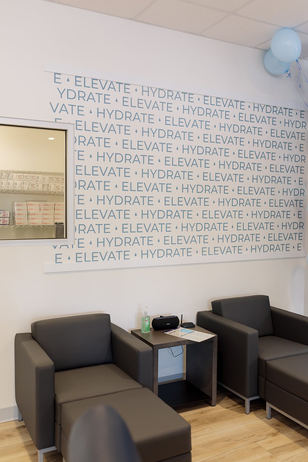The quiet waiting area at Hydralive Huntersville with the Hydrate Elevate wall