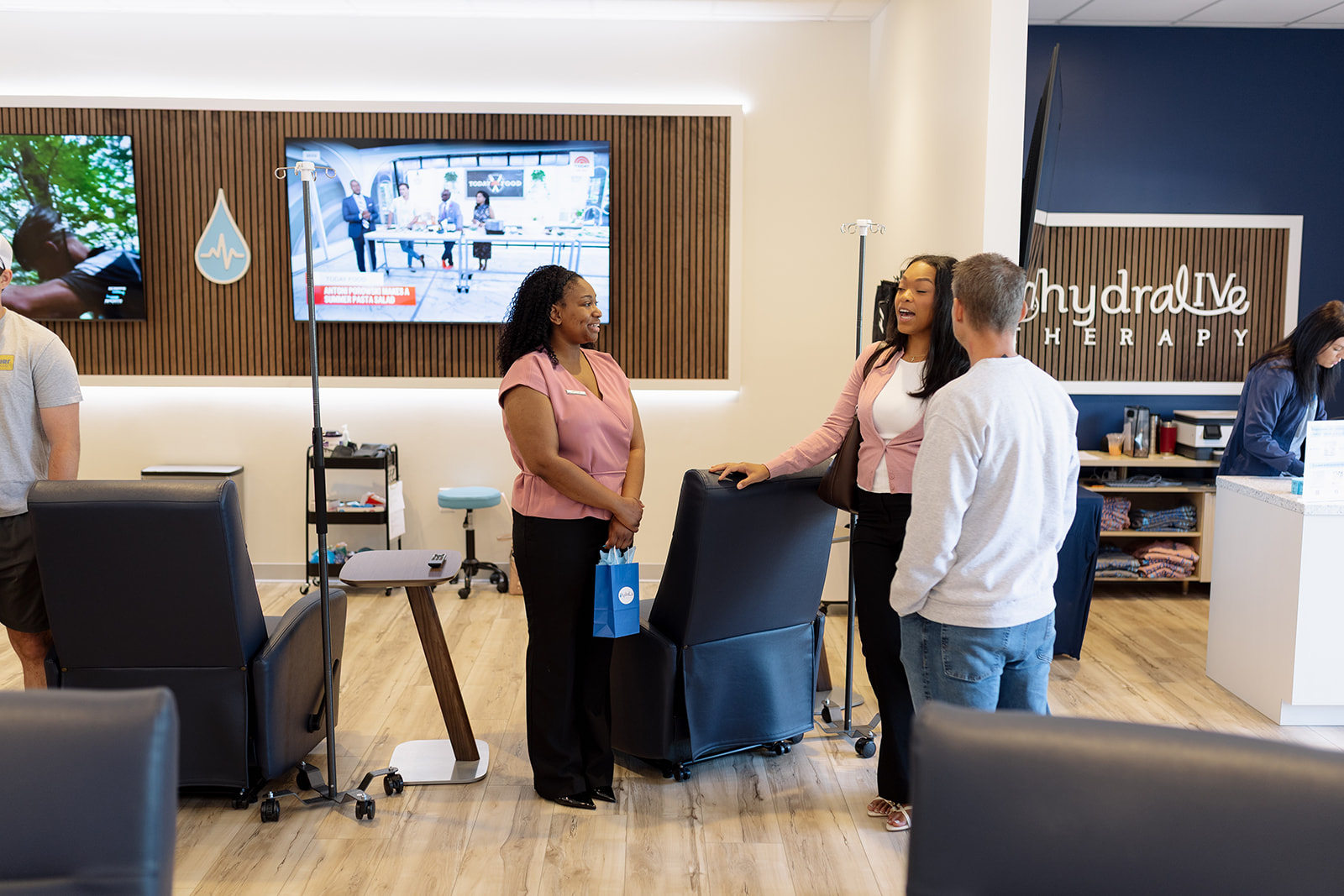 The IV lounge at Hydralive Therapy Huntersville: recliners, IV poles and the hydralIVe wall sign