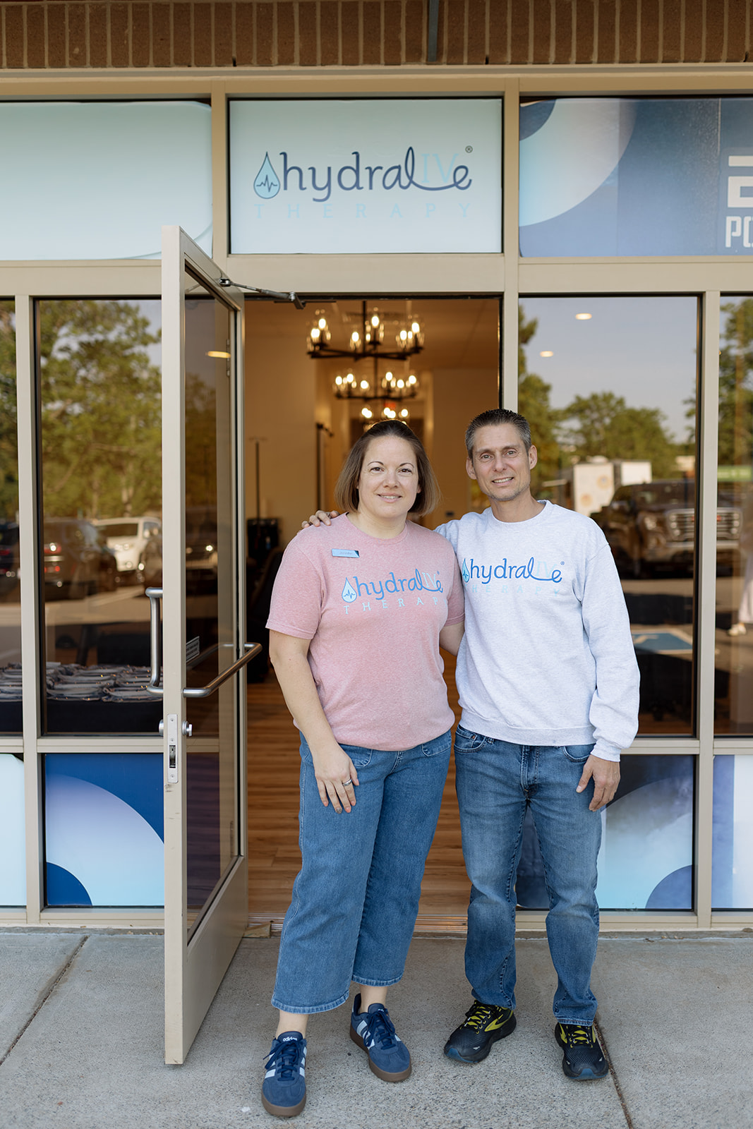 Jennifer and Anthony, the owners, standing at the front door of Hydralive Therapy Huntersville