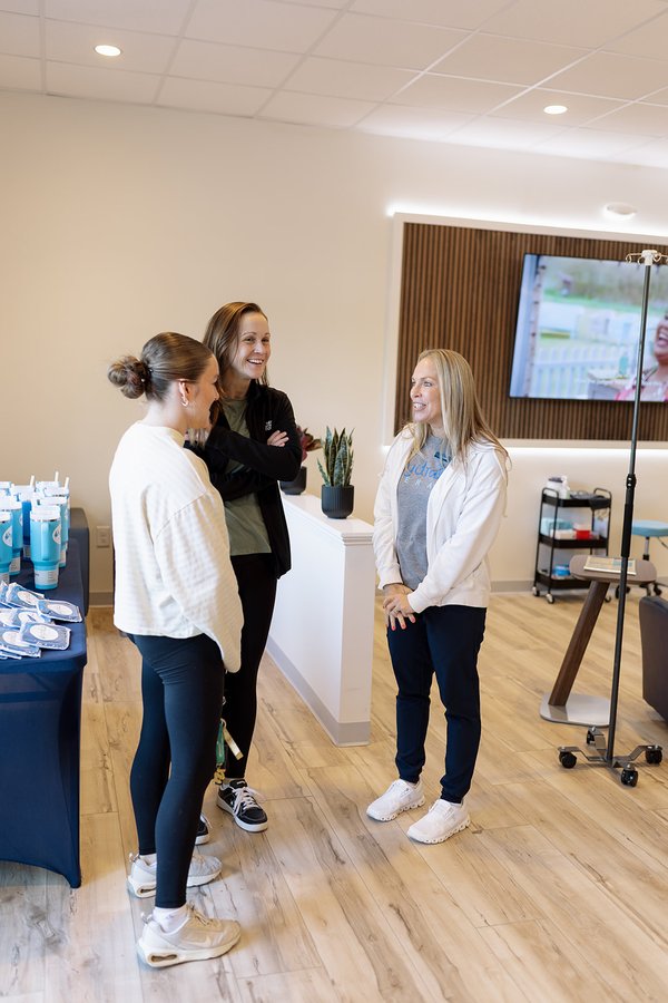 Clients relaxing beside an IV pole in the Hydralive Huntersville lounge